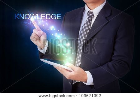 Businessman holding tablet with pressing start. internet and networking concept