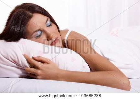 Young woman laying and sleeping on the bed