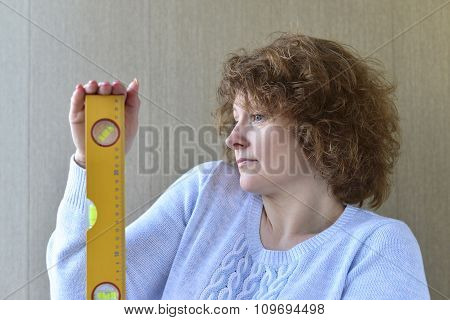 woman is holding construction tools