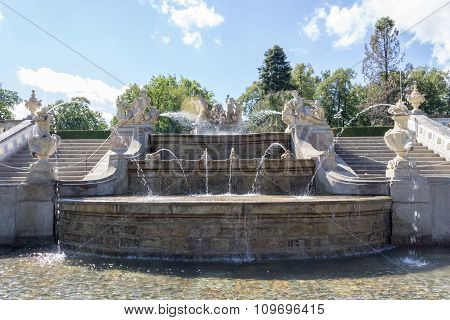 A fountain near a castle.