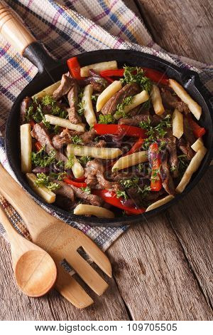 Homemade Peruvian Cuisine: Lomo Saltado In A Pan Close-up Vertical