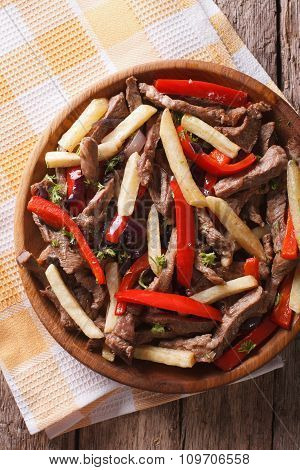 Peruvian Cuisine: Lomo Saltado Close-up On A Plate. Vertical Top View