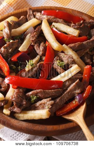 Peruvian Cuisine: Lomo Saltado Close-up On A Plate. Vertical