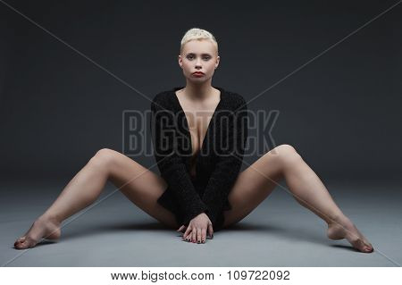 Beautiful young woman sitting with legs spread