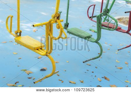 Empty hourse swings on summer kids playground