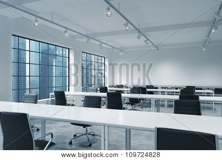 Workplaces In A Bright Modern Loft Open Space Office. Empty Tables And Docents' Book Shelves. Singap