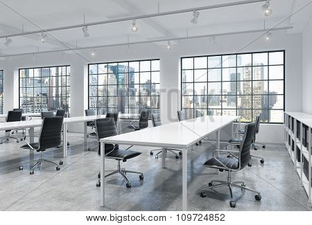 Workplaces In A Bright Modern Loft Open Space Office. Empty Tables And Docents' Book Shelves. New Yo