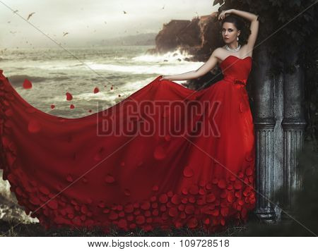 Beautiful young woman in long red dress