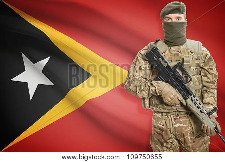 Soldier Holding Machine Gun With Flag On Background Series - East Timor