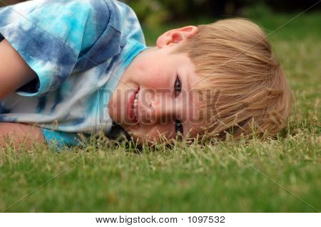 Boy Lying In Grass