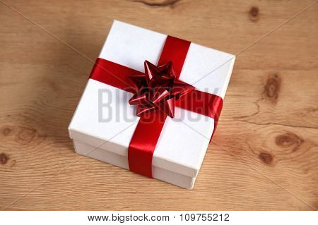 New Year gift on a golden tinsel background boly