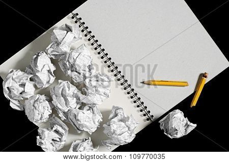 Notepad And Crumpled Paper Balls