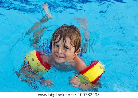 little boy having fun in an swimming pool