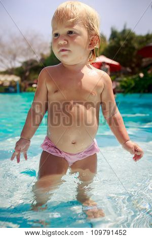 Closeup Small Girl Stands Looks Into Distance In Shallow Water
