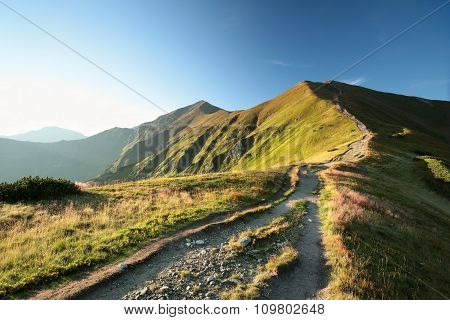 Panorama of Tatra Mountains Carpathians sun sunset path trail road Nature background Nature landscape Nature background sky colors vibrant Nature Travel Tourism hiking Adventure Mount Nature background sunrise Nature background Summit Peaks mountain.