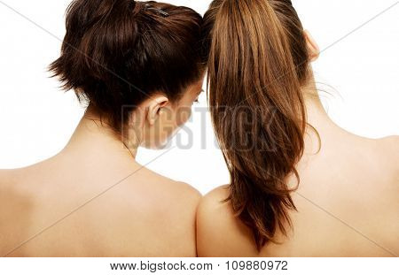 Two attractive topless women with beautiful hair.