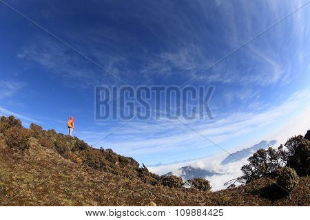 young woman hiker hiking on mountain peak