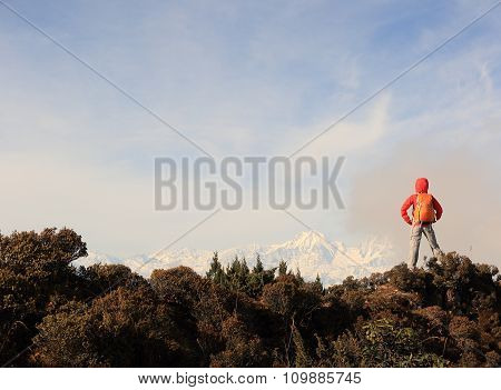 young woman hiker hiking on mountain peak