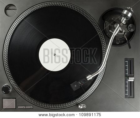 Turntable playing vinyl close up with needle on the record with grey background