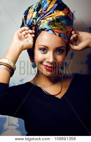 beauty bright african american woman with creative make up, shawl on head like cubian closeup