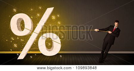 Business man pulling rope with big procent symbol sign concept on background