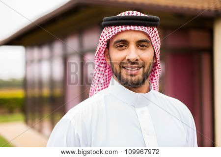 portrait of middle eastern man outside the house
