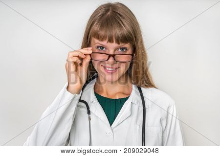 Portrait Of Successful Doctor With Stethoscope On White