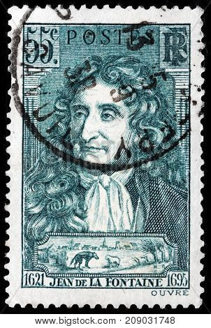 LUGA RUSSIA - OCTOBER 6 2017: A stamp printed by FRANCE shows image portrait of Jean de La Fontaine - a French fabulist and one of the most widely read French poets circa 1938