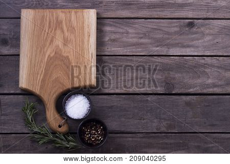 Cutting Board, Rosemary And Spices On A Old Wooden Table. Copy Space. Concept For Restaraunt Cafe Bi