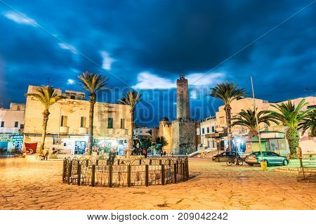 Night photo of street with Ribat castle in Sousse. Medieval architecture in night lights. Vivid picture of ancient religious building - one of the main attractions in Sousse, Tunisia.