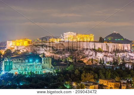 Parthenon and Herodium construction in Acropolis Hill in Athens, Greece shot in blue hour with