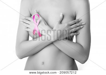 Breast cancer. Pink ribbon on a woman's breasts. Concept of medicine and health care