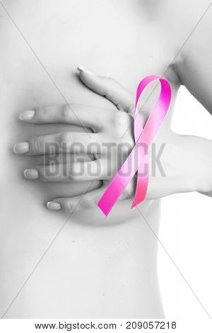 Breast cancer. Pink ribbon on a woman's breasts. Concept of medicine and health care