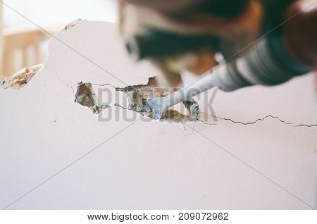 Construction worker using pneumatic hammer construction site concept.