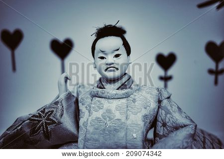 Japanese doll face fear in dark Background.