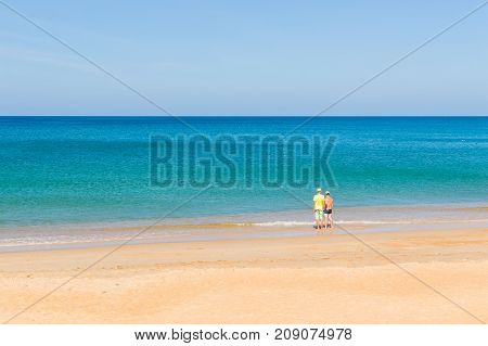 Two Mans Looking At The Sea On The Tropical Beach, Relaxed, Concept Of Freedom