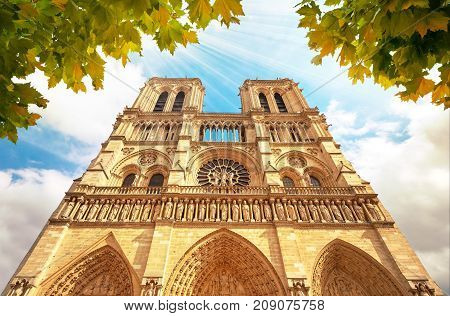 Notre-dame Cathedral In Paris France With Golden Light Rays.