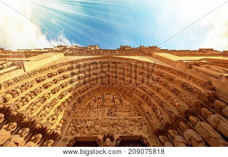 Notre-dame Cathedral In Paris France With Golden Light Rays.