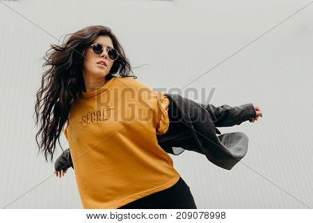 Portrait Of Stylish Modern Young Curly Woman In Coat Sunglasses