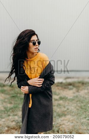 Portrait Of Stylish Modern Young Curly Woman In Coat Sunglasses