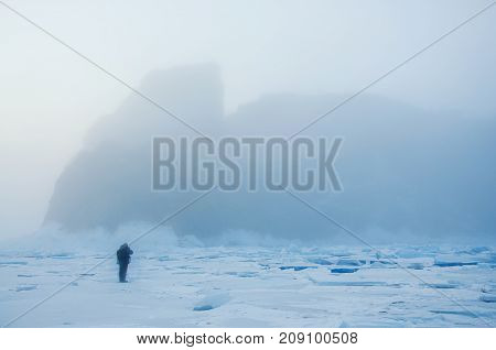 Field of blue ice and rocks Hoboy with sun. Russia. Lake Baikal