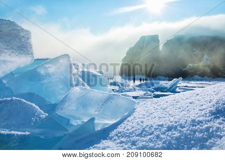 Field of blue ice and rocks Hoboy with sun. Russia. Lake Baikal