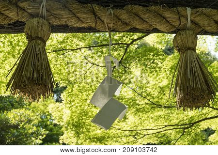 Kyoto, Japan - May 20, 2017: Shimenawa, special plaited rope and shime, strips of white paper, placed at the entrance of a holy places to ward off evil spirits
