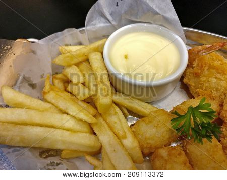 French fries and Nuggets in dish with mayonnaise sauce