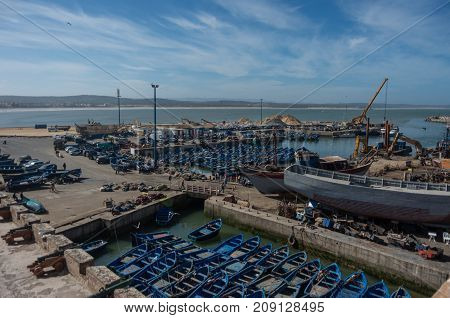 Essaouira, Morocco - May 6, 2017 : View to fishing boats in Essaouira harbour and cannons in Skala du Port ( Northern Skala ) Morocco