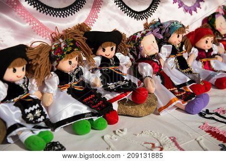 Romanian handmade dolls in traditional costumes in a fair