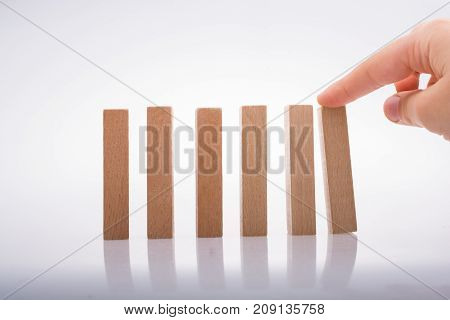 Hand Holding Wooden Domino