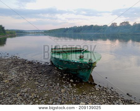 Boat At The Shore Of Wide River