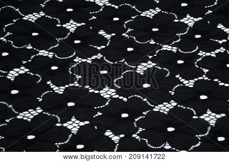Black guipure lies flat on a white base
