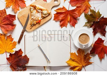 Autumn breakfast with coffee, pizza and diary. Top view concept.